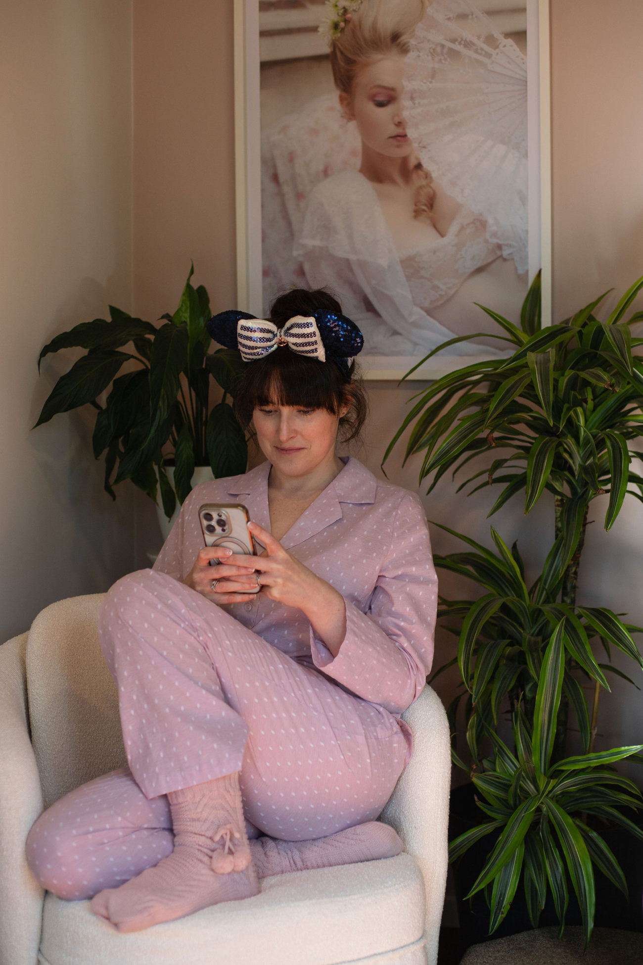 Amélie at home in a relaxed moment, warm natural light across the room.