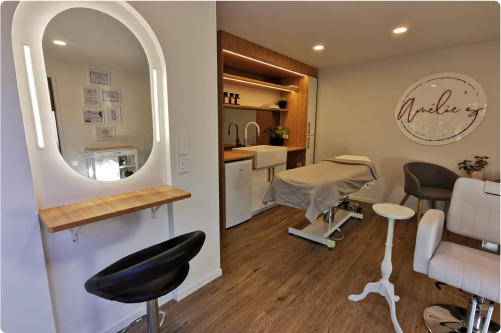 The cocoon, with its makeup station and massage table, cozy ambiance