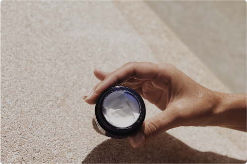 Hand holding a white cream product