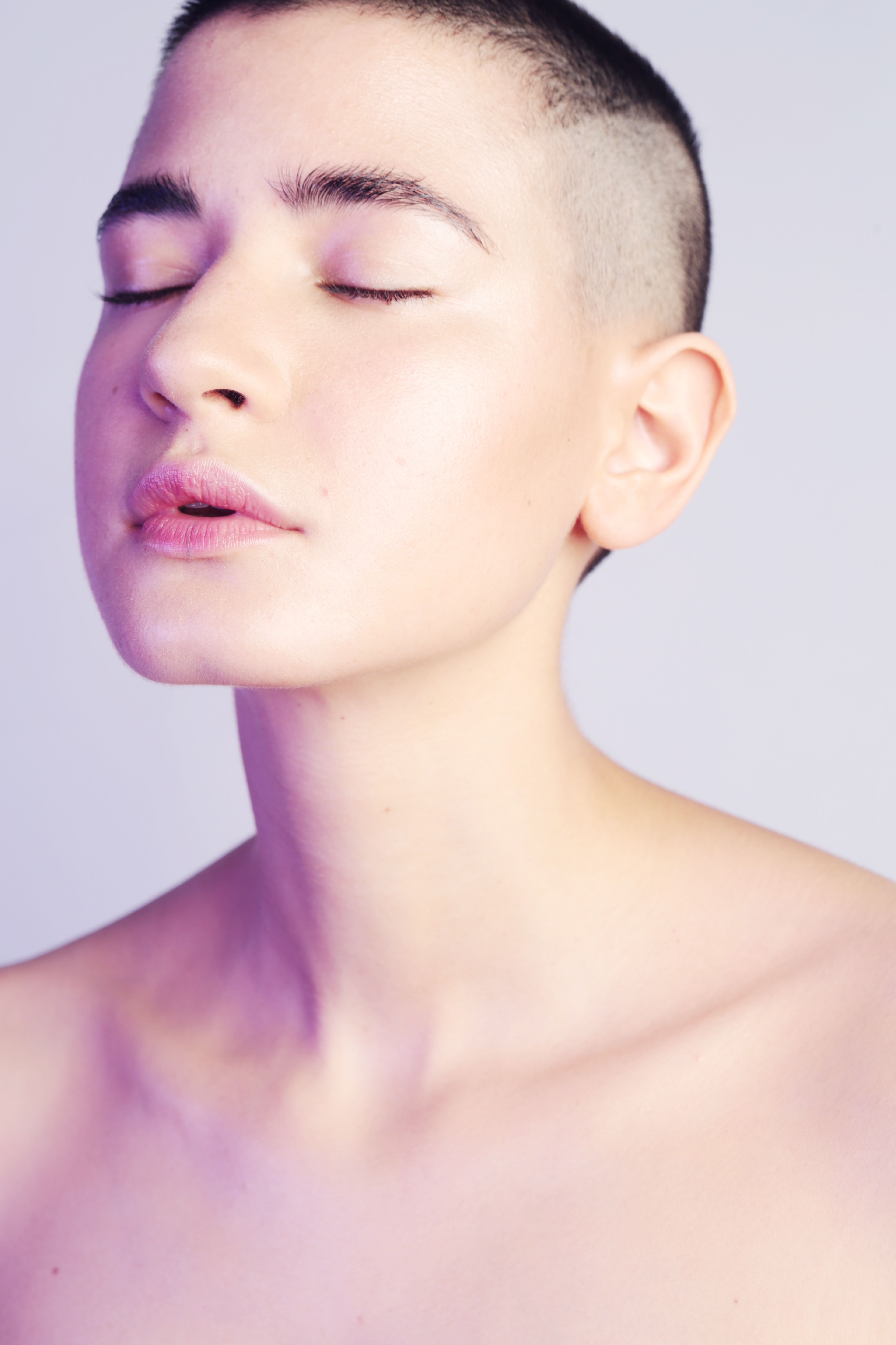 A woman with calm, radiant, healthy-looking skin in soft natural light